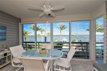 Enclosed glass lanai overlooking bay. 