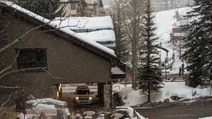 A pool area with a stone deck, surrounded by snow-covered ground and trees. - Immediate ⛷ In/out,  🏔 views,  walk 2 village, PERFECT location, OFP, Pool&HotT (Avon)