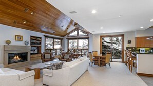 A spacious living room with a fireplace, large windows, and a cozy seating area. - Immediate ⛷ In/out,  🏔 views,  walk 2 village, PERFECT location, OFP, Pool&HotT (Avon)