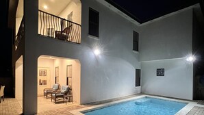 Un bâtiment à deux étages doté d’une piscine, d’un espace extérieur aménagé et d’un balcon.