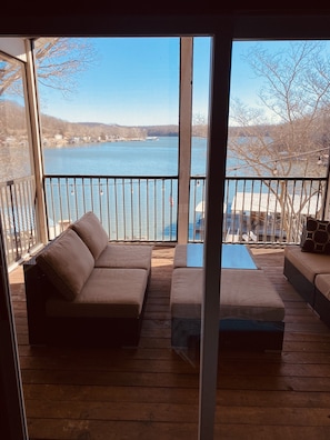 Enjoy the serene view of the water from the balcony's comfortable seating area.