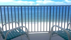 A balcony with two white metal chairs facing a beach with a clear view of the ocean.