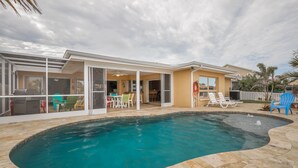 A modern house with a swimming pool, patio furniture, and a covered outdoor area. -  The Crab Shack,Paradise on the Gulf includes pontoon boat  and salt water pool. (New Port Richey)