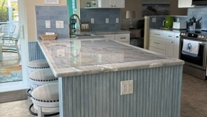 A kitchen with a central island, white cabinets, a microwave, and a stove. -  The Crab Shack,Paradise on the Gulf includes pontoon boat  and salt water pool. (New Port Richey)