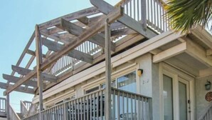 A building with a balcony, a door, and a window. - Wanna Sea #202 - Newly Renovated Balcony! (Fernandina Beach)