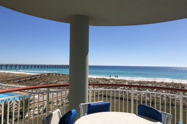 The large balcony has a fabulous view and a warm summer breeze .