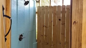 A wooden door with a sign indicating a 5-minute shower.