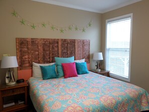 A bedroom with a wooden headboard, a floral bedspread, and a string of green stars on the wall. - -PRIVATE POOL-1 BLK TO BEACH-OUTDOOR DINING/KITCHEN-PET & FAMILY FRIENDLY! (Murrells Inlet)