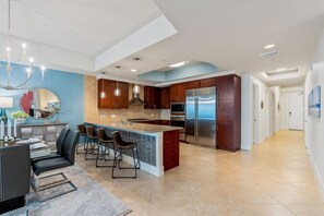 Enjoy cooking in this kitchen with a central island, bar stools, and a sleek sink.