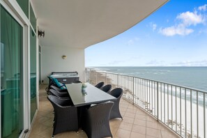 Enjoy ocean views from this balcony with a table, chairs, and grill.