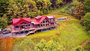 A large, multi-story lodge with a red roof, a deck, and a swimming pool. - Incredible Mtn Views - 106 Acres: Private Pool, Pickleball Fall of 2026 (Zionville)