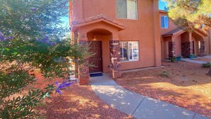 A two-story house with a stone facade, a front door, and a small porch. - Kanab Retreat Near Zion w/ Pool & Hot Tub (Kanab)