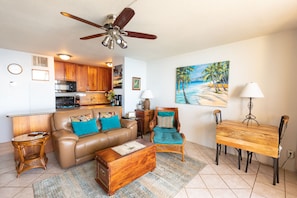 Relax in this inviting living space with a cozy seating area, dining table, and fully equipped kitchen.