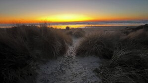 A sandy path leading to a beach with a sunset in the background. - Beautiful Manzanita Getaway- Perfect for Family Large or Small - MCA #769 (Manzanita)