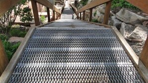 A wooden staircase with metal grating leading to a building. - GREAT OLD TOWN LOCATION- SKI TO TOWN LIFT & STEPS TO MAIN ST!  (Park City)