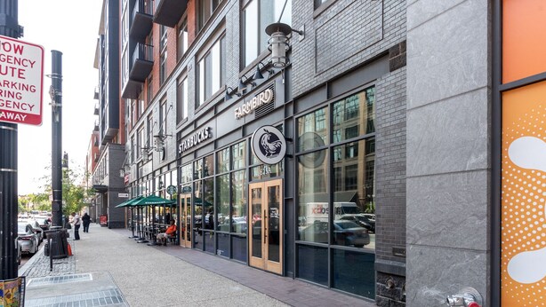 A storefront with a Starbucks sign, a visible fire hydrant, and a pedestrian walkway. -  Luxe Three floors. Four bedrooms each with private full bath  Garage Parking (Washington)
