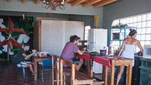 Cocina rústica con muebles de madera, un refrigerador y una ventana con vistas.