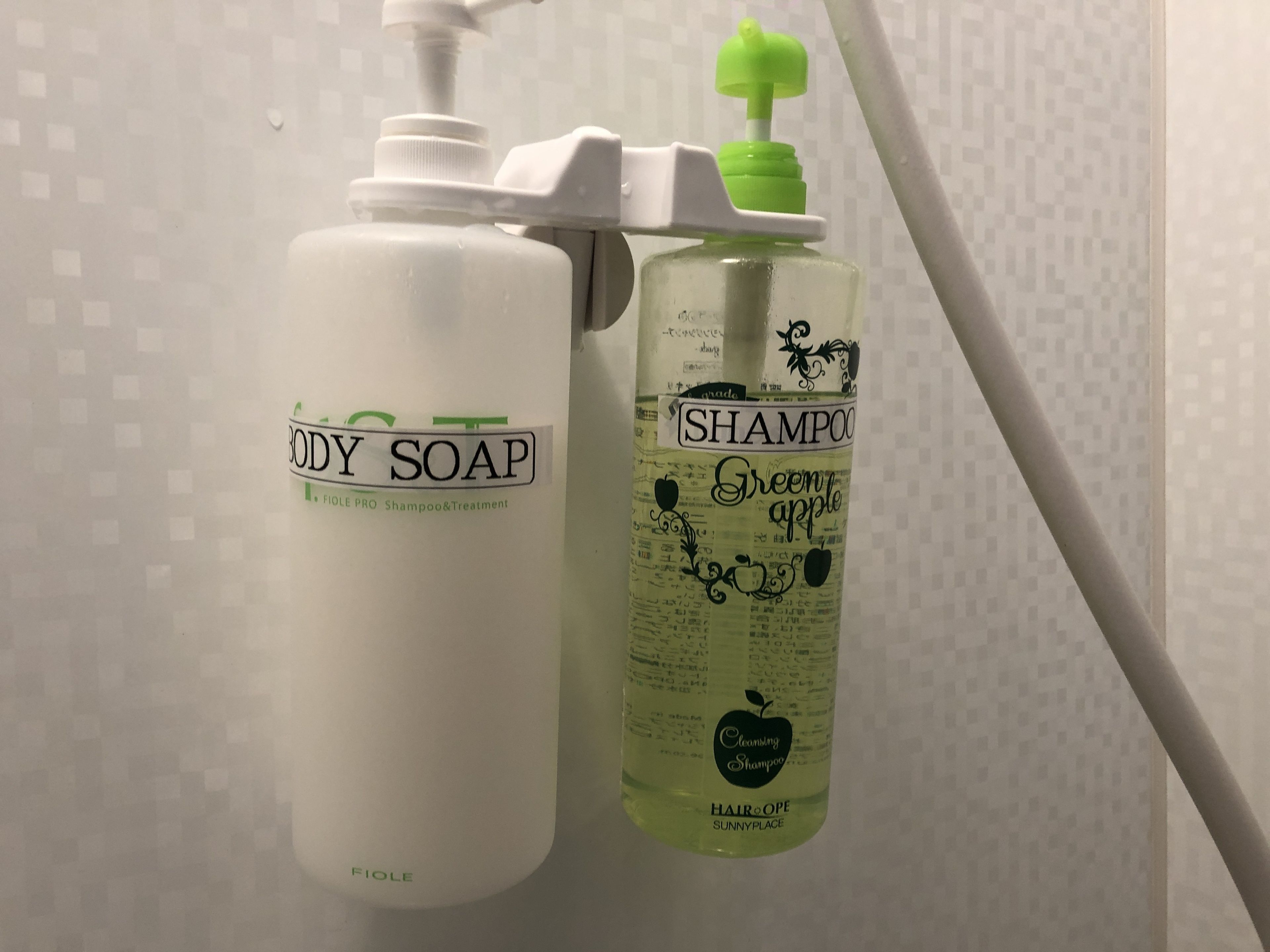 Two bottles of body soap and shampoo.