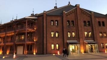 A large brick building with multiple windows and a covered entrance.