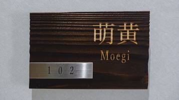 A room number plaque with the number 102 and the name "Moegi" in both English and another script.