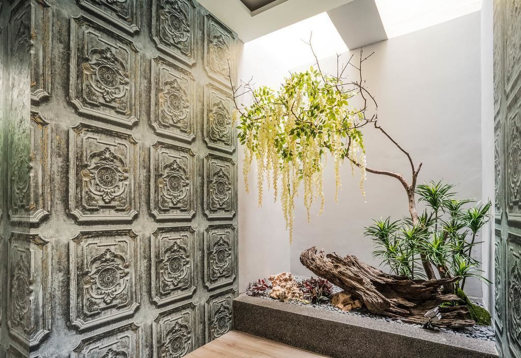 A room with ornate wall paneling and a hanging plant.