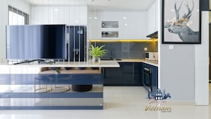 A modern kitchen with a built-in oven, a sink, and a countertop. - Stay In Vietnam River Gate (Ho Chi Minh City)