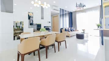 A modern living room with a dining area, a sofa, and a coffee table.