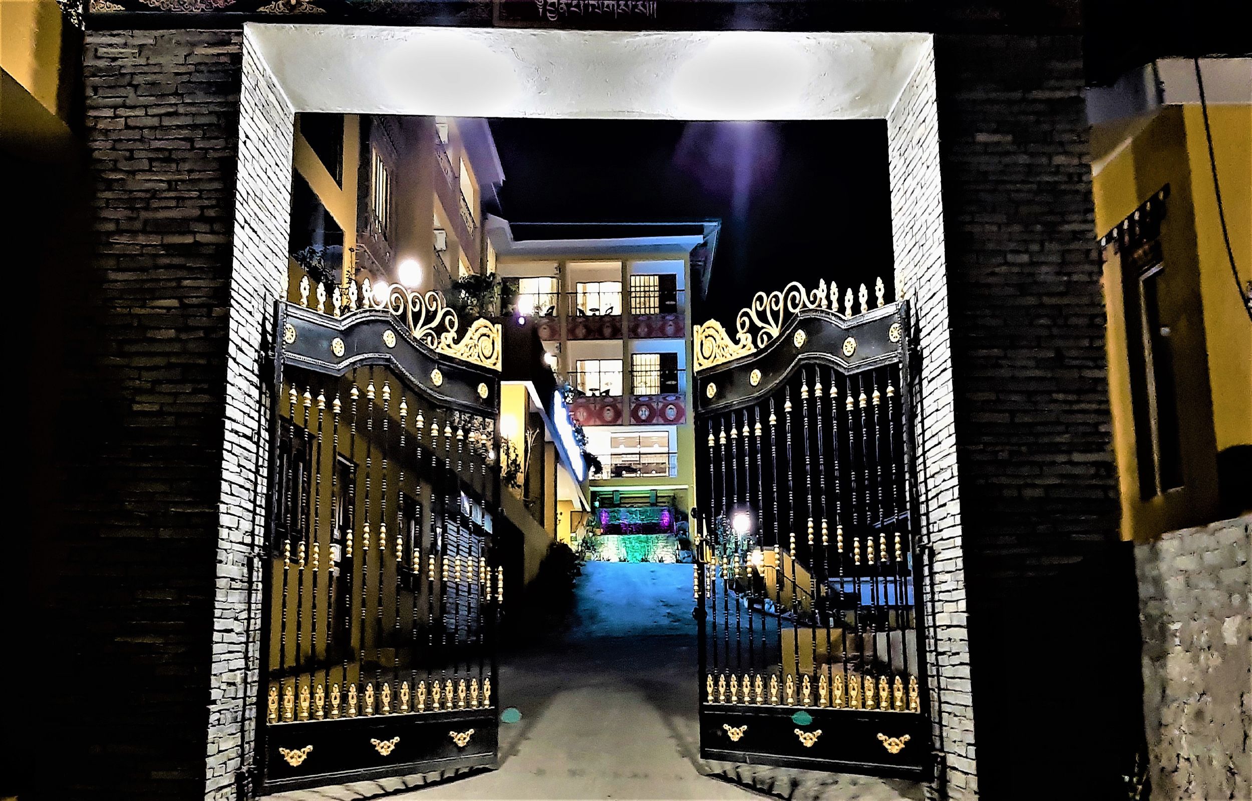 A gated entrance to a building with a staircase leading to an upper level.