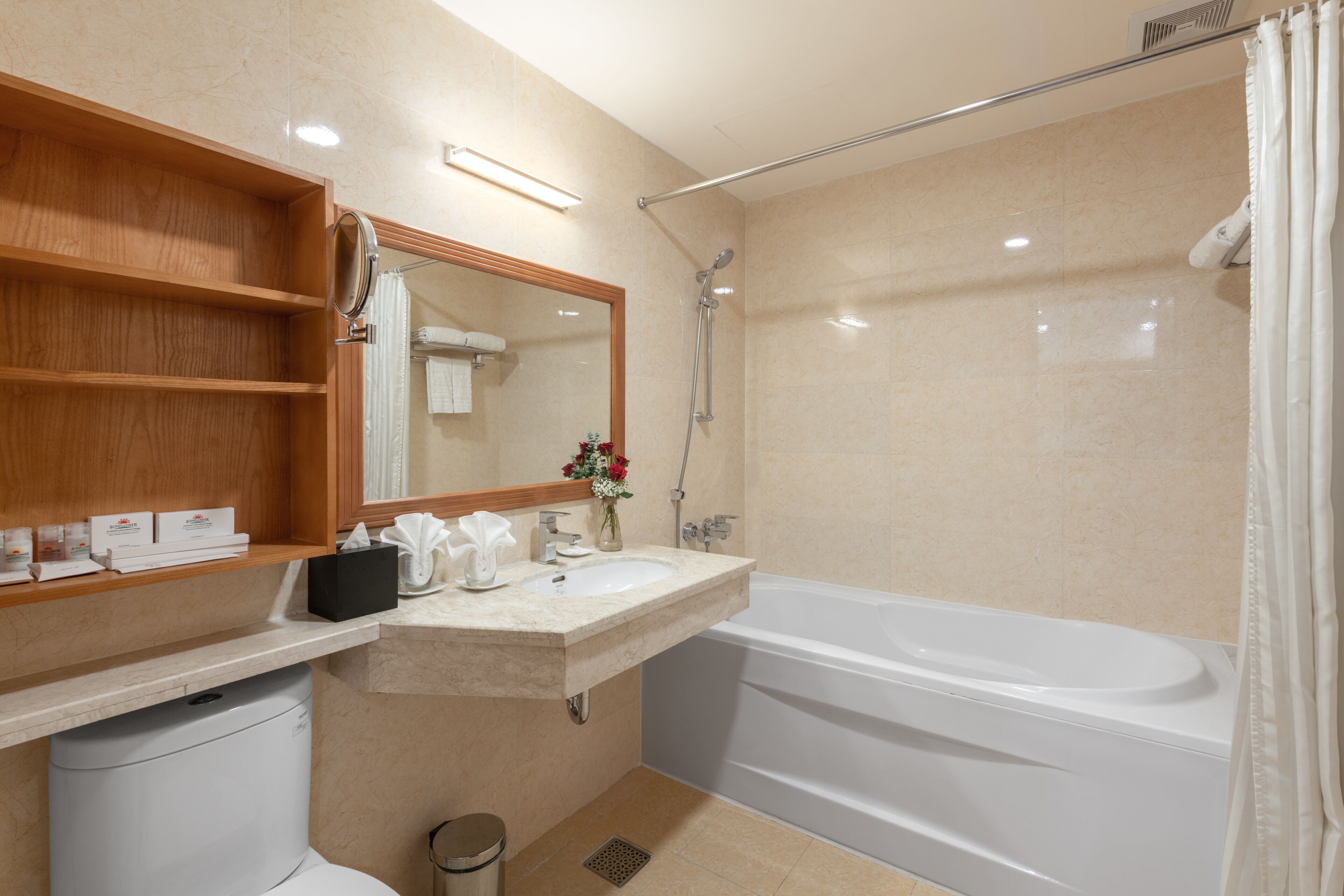 A bathroom with a bathtub, a sink, a mirror, and a shower.
