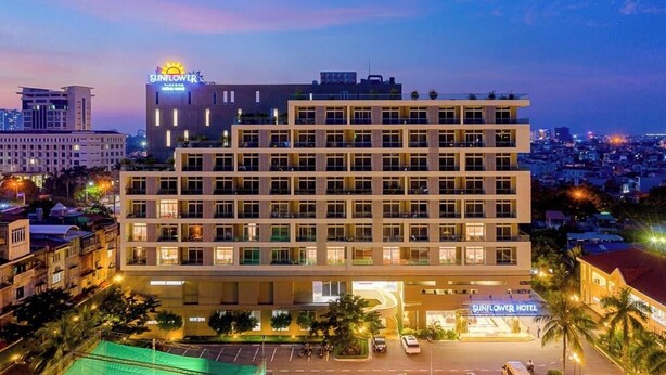 A multi-story hotel with a modern design, featuring a prominent sign for the Sunflower Hotel. - Sunflower International Village (Hai Phong)