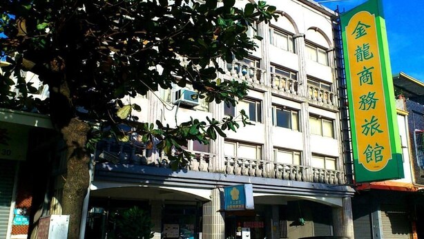 A multi-story building with a prominent green sign on the right. - Jin Lon Hotel (Taitung)