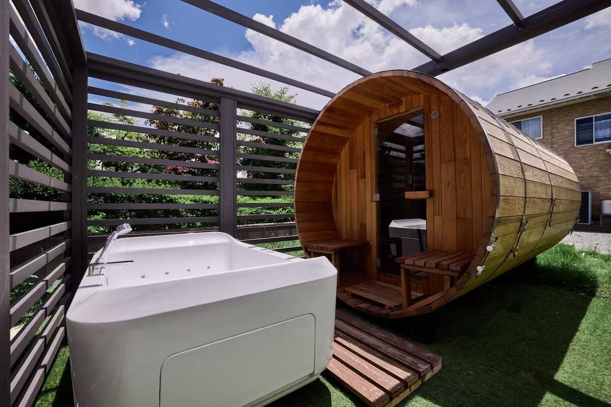 A spa area with a wooden sauna and a white jacuzzi.