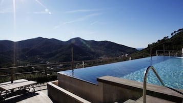 Seasonal outdoor pool, open 9:30 AM to 8:00 PM, pool loungers