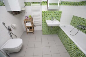 A bathroom with a toilet, sink, and bathtub. - Greg Apartments Kampa Prague (Prague)