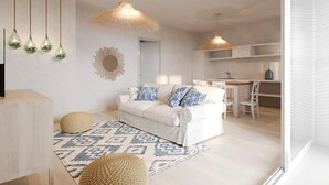 Un salon moderne avec un canapé blanc, un tapis à motifs et des lampes suspendues.