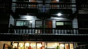 Un edificio de varios pisos con una tienda en la planta baja.