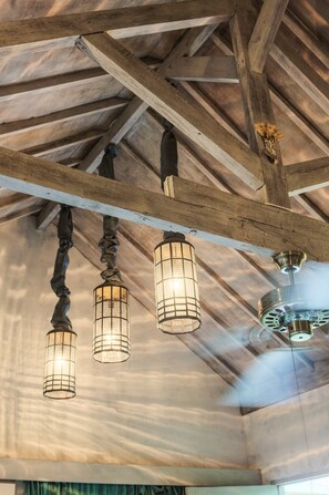 A ceiling with exposed wooden beams and hanging lantern-style lights. - Villa Barissan (Seminyak)