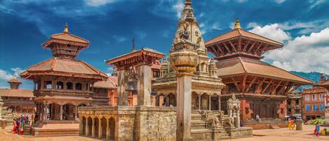 A traditional building with multiple structures, including a central stupa and surrounding smaller buildings.