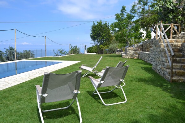 Seasonal outdoor pool, open 9:00 AM to 7:00 PM, pool loungers