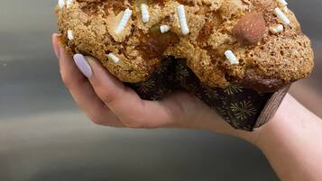 A muffin with almonds and white sprinkles.