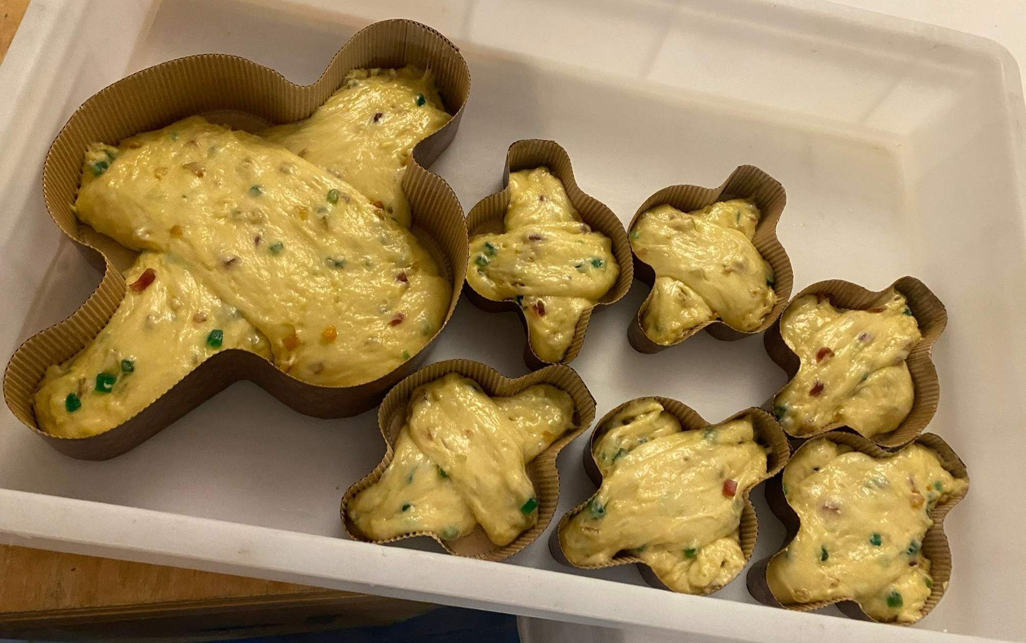 A tray of baked goods in paper cups.