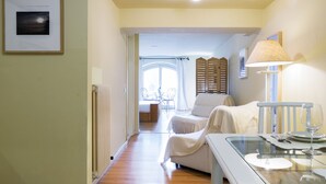 A hotel room with a bed, a dining table with a glass top, a lamp, and a framed picture on the wall. - Lake Panorama (Como)