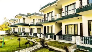 A row of modern, multi-story hotel buildings with balconies and large windows. - Van Durga Villas & Suites Katra (Reasi)