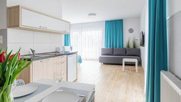 Quadruple Room, Kitchenette | Laptop workspace, blackout drapes, iron/ironing board, free WiFi