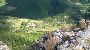 A mountainous landscape with a village nestled in the valley.