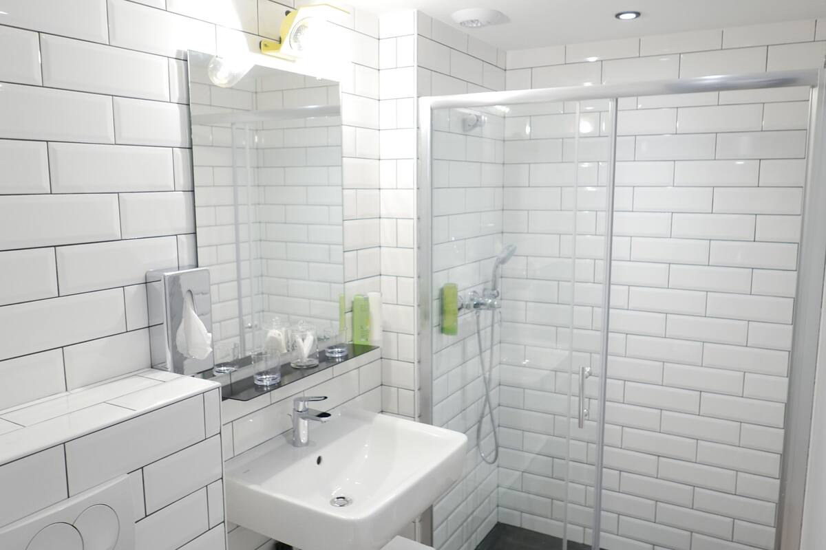 shower, rainfall showerhead, hair dryer, towels