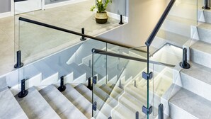 A modern staircase with glass railings and a potted plant on the landing. - Wine & Pillow Hotel by Frapolli (Odesa)