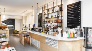 A modern bar area with a wine cellar, bar stools, and a variety of bottles and glasses. - Wine & Pillow Hotel by Frapolli (Odesa)