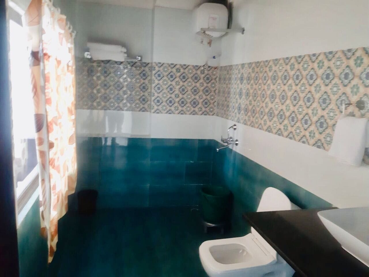 A small bathroom with a toilet, a sink, and a shower.