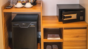 A compact kitchenette with a microwave, coffee maker, and a small refrigerator.